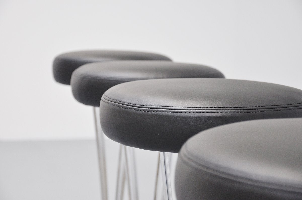 This is for a very nice set of bar stools, designed by Piet Hein for Fritz Hansen, Denmark 1985. These stools have chrome plated frames and a brushed aluminum base. We have newly upholstered them with black supreme quality leather by Hulshoff. Very