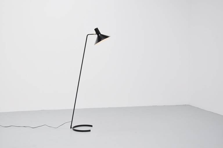 Very nice floor lamp designed by JJM Hoogervorst for Anvia, Holland 1960. This floor lamp has a nice C shaped foot, which is unique in its kind. The shade and base are black lacquered, the lamp is completely original and only the shade has a very