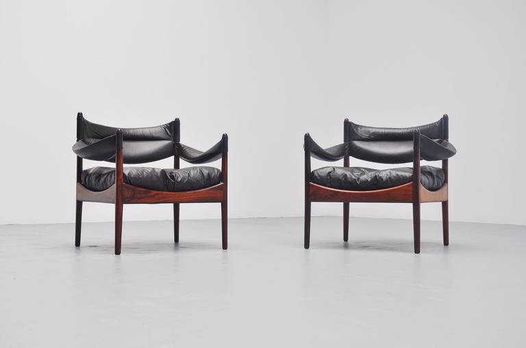 Very nice pair of low easy chairs designed by Christian Solmer Vedel for Soren Willadsen Mobelfabrik, Denmark 1963. The chairs are from the Modus series, made of solid rosewood frames and black lather cushions. Comfortable chairs, great looking