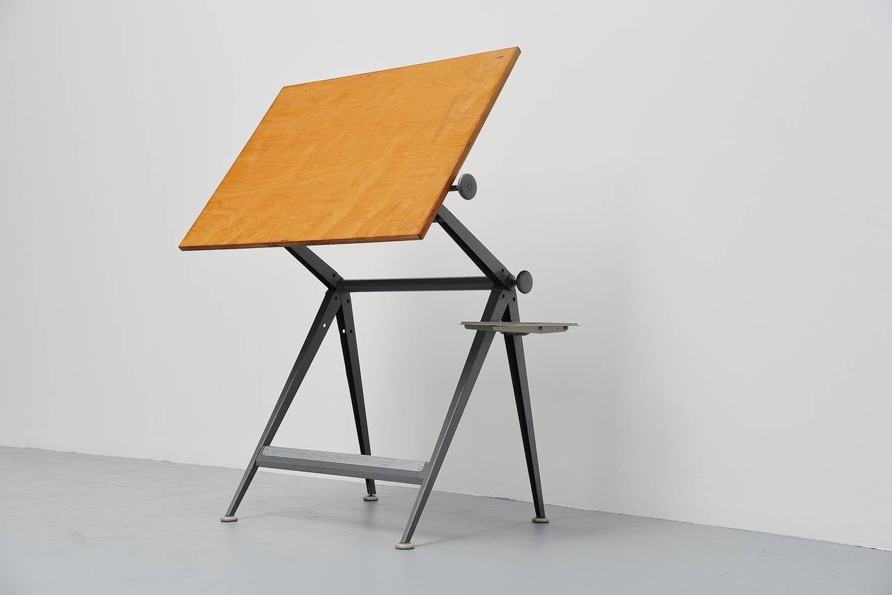 Ingenious drafting table designed by Wim Rietveld and Friso Kramer for Ahrend de Cirkel, Holland 1963. The table is adjustable in numerous positions using an ingenious adjusting system using only 2 screws at the side. This table won a ´Signe d´Or´