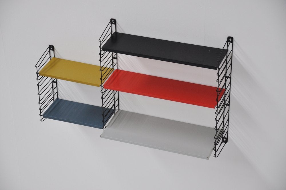 World known bookcase wall unit designed by D Dekker for Tomado in 1960. Everybody had it in the 60's Tomado! A true Icon of Dutch modernism and industrial design. This very nice complete unit excists with 3 large shelves included 1 deep, 2 small