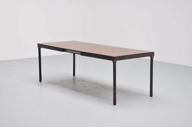 Very nice extendable dining table designed by Inger Klingenberg for Fristho Franeker, Holland 1960. This rosewood dining table has some very nice details, on the corners you will find some dovetail connections and a metal square tag to finish the