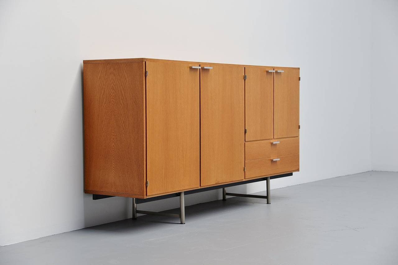 Fantastic grained buffet from the made to measure series designed by Cees Braakman for Pastoe, Holland, 1965. This oak veneered buffet has a nice and warm color wood. It has solid aluminum handles and a chrome-plated metal base. This buffet provides