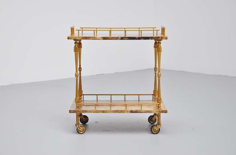 2 Tier brown goat skin covered serving cart, with brass gallery edge and handles, carved arced pull handles and wheel posts, This is designed by Aldo Tura for Tura Milano ca 1960. Cart is in splendid original condition.