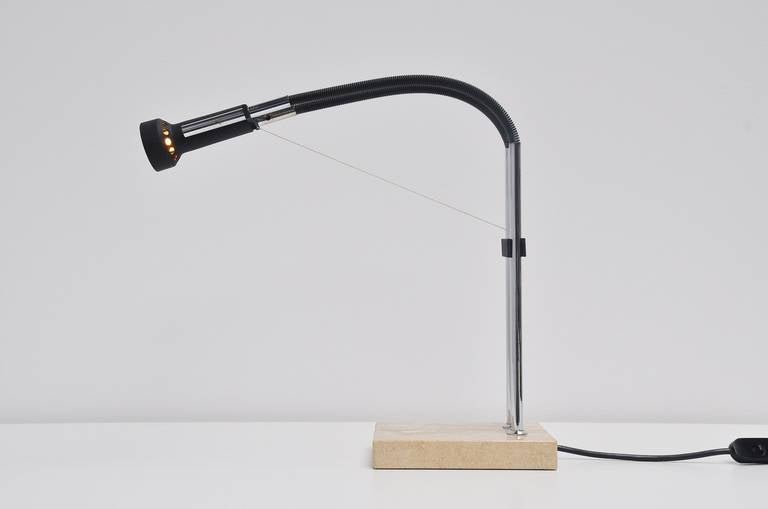 Articulating table lamp designed by Angelo Lelli for Arredoluce, Italy 1960. This is for a very small table lamp on a travertine base, the lamp adjusts height though a counter-weight and wire system attached to two chrome supports on the base. Very