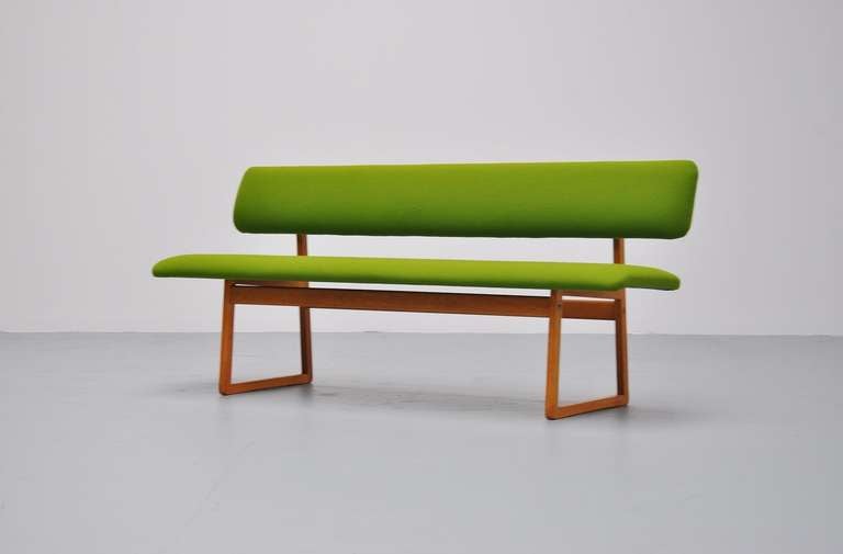 Very nice bench in the manner of Borge Mogensen, new green upholstery with oak slipper frame. Very nice modernist bench and superb connected oak frame.