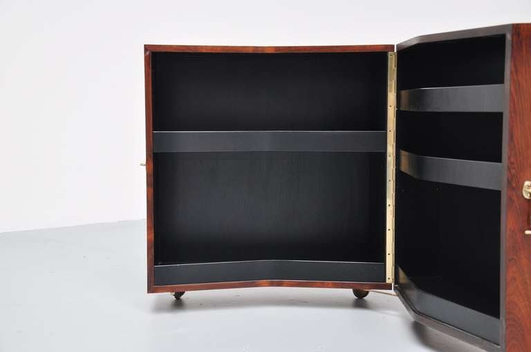 Fantastic shaped small liquor cabinet with black inside, designed by Rosengren Hansen for Brandt Mobelfabrik. High quality veneer and beautiful warm grain. Fully restored with UV protection lacquer and in excellent condition. Superbly finished and