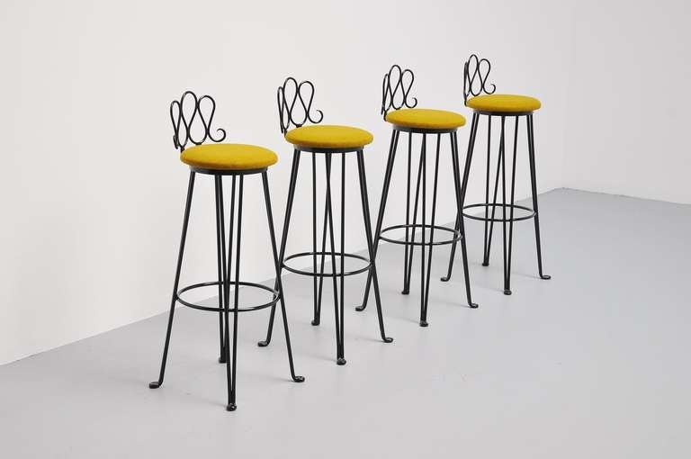 Fantastic and super heavy solid metal bar stools, black lacquered and amazing shaped and great contrast with the greenish kvadrat fabric Tonica. These stools seat fantastic and are really amazing. In the manner of Mathieu Mategot.
