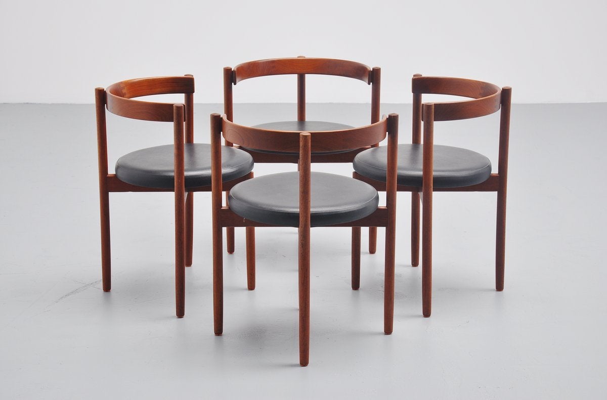 Excellent set of dining chairs in uncommon shape, designed by Hugo Frandsen for Børge Søndergaard, Denmark 1964. These chairs have solid teak wooden frame and black vinyl upholstery. The chairs are still fully original and in excellent well kept