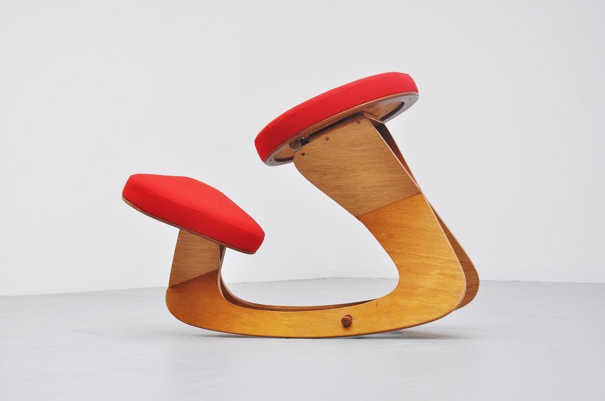 Very nicely shaped ergonomic stool made and designed by Hugo, unknown artist from Holland 1990. Very nicely shaped stool in teak plywood and newly upholstered in bright red de Ploeg upholstery. This seats very nicely for you back and it looks great