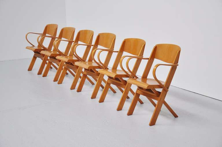 Fantastic set of 24 Dutch plywood folding chairs. very easy stackable and very comfortable seating pleasure. With very nice patina to the wood but all in very good condition. Hard to find set of 24 chairs.