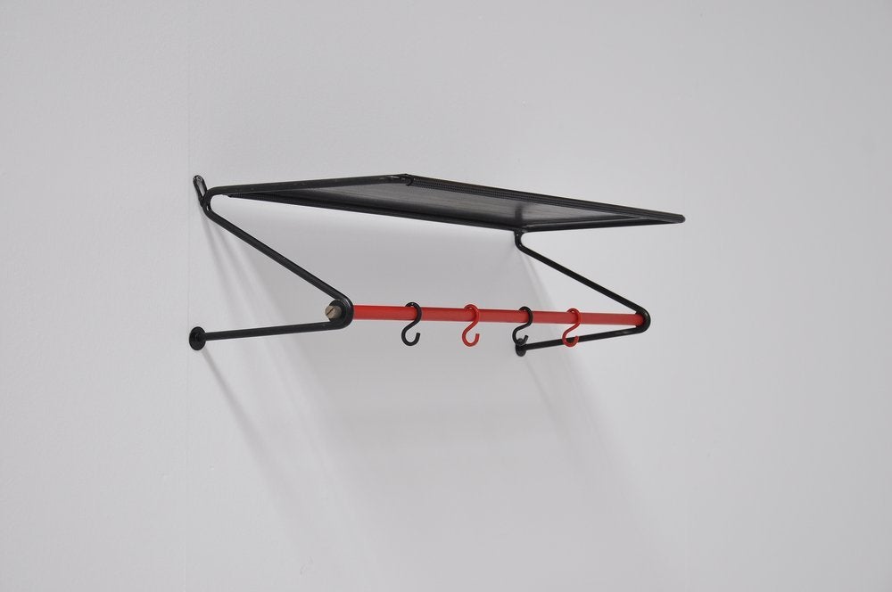 Very nice coat rack designed by Mathieu Mategot for Artimeta Soest, Holland 1950. This is a licensed product by Artimeta Soest who could make the Mategot products in Holland, documentation available. This coat rack is in black and has a red bar.