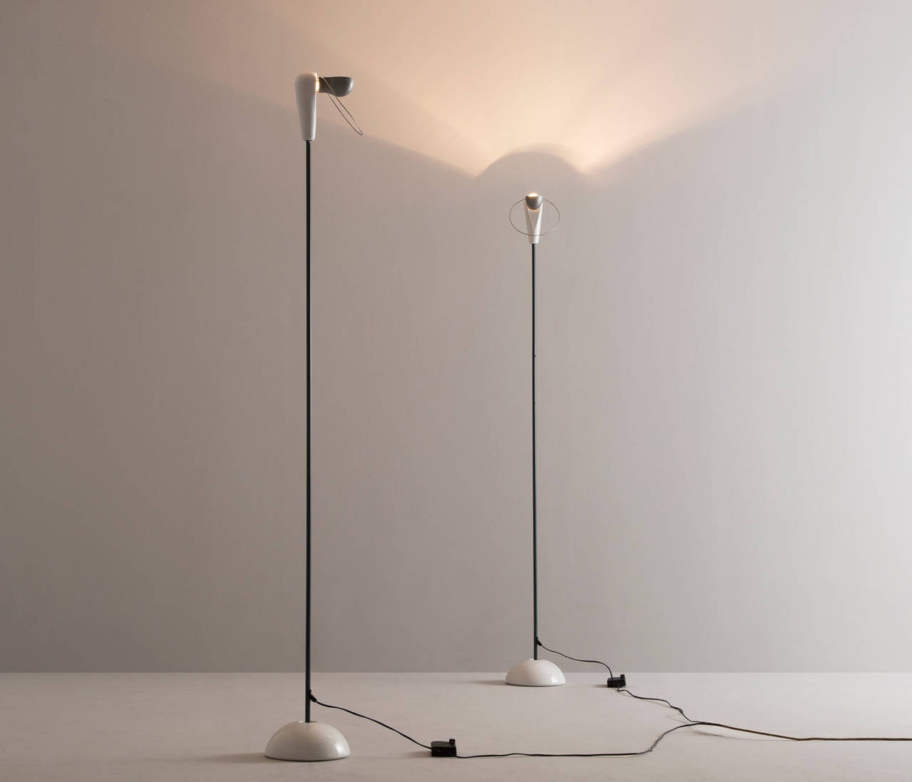 Matching set of 2 'Bi-Bip' Floor Lamps designed by Achille Castiglioni manufactured by Flos, Italy.
 
These floor lamps have a very elegant and subtle design. The slim stem support an ceramic head. A round designed steel screen can be rotated