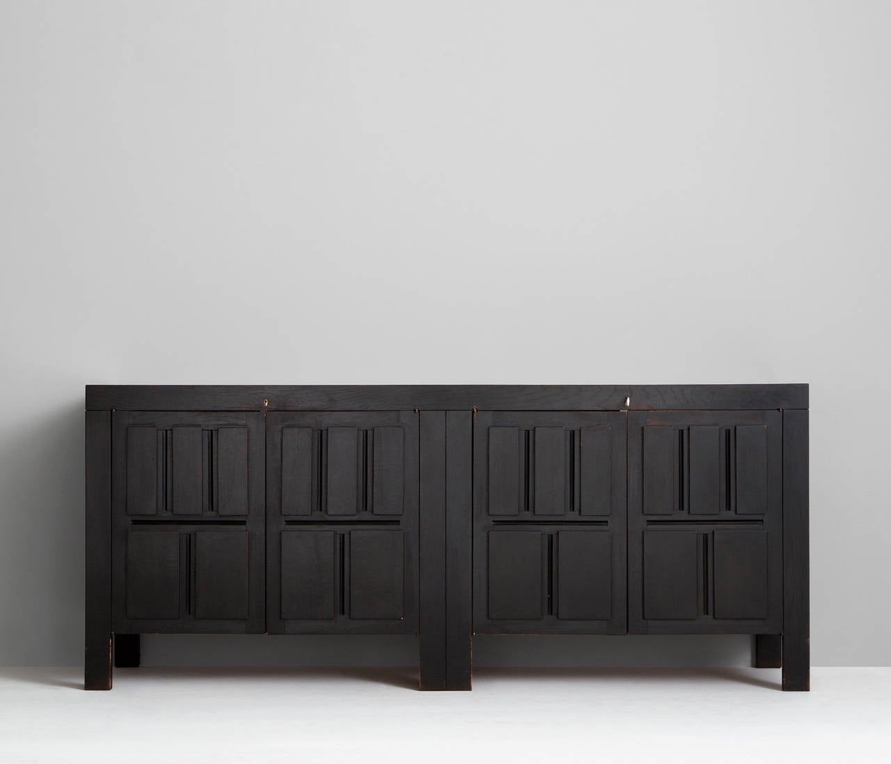 Sideboard, in wood, by De Coene, Belgium 1970s.

Very well designed graphic credenza with dark brown stained finish designed by de Coene, Belgium. The matte dark brown finish is a perfect combination with the graphing panels because of the high