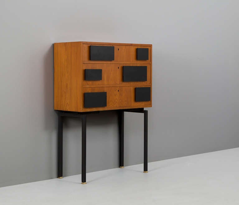 Cabinet, in ash and metal, Sweden, 1950s. 

A nicely designed chest of drawers on a high metal stand. The incremented black squares really stand out on the ashwood console and matches beautifully on the high standing frame.

Free shipping for