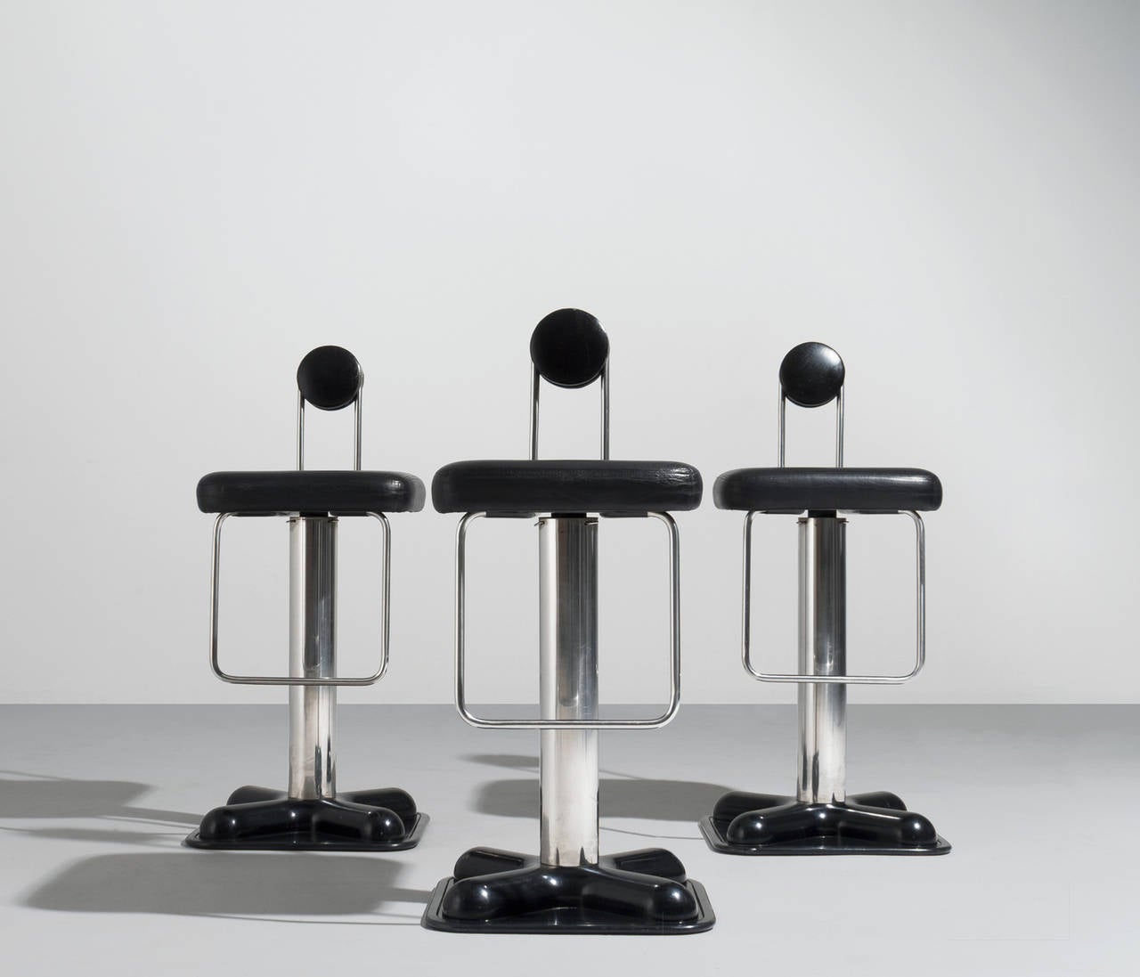 Set of three remarkable swiveling bar stools designed by Joe Colombo 'Birillo' for Zanotta, 1971. With original well preserved black leather upholstery, chrome steel base and a black plastic feet. The construction is completely checked.

These