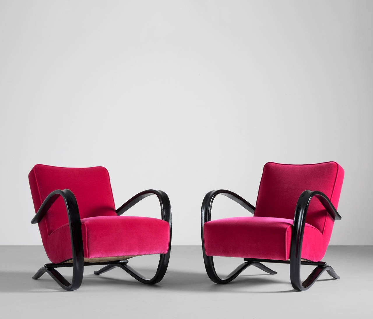 Jindrich Halabala lounge chairs, Czech Republic, 1930s 

Very dynamic chairs with curved bases that fluently end in the armrests.
These easy chairs are completely refurbished and also reupholstered in a distinctive Kvadrat fabric, which is in