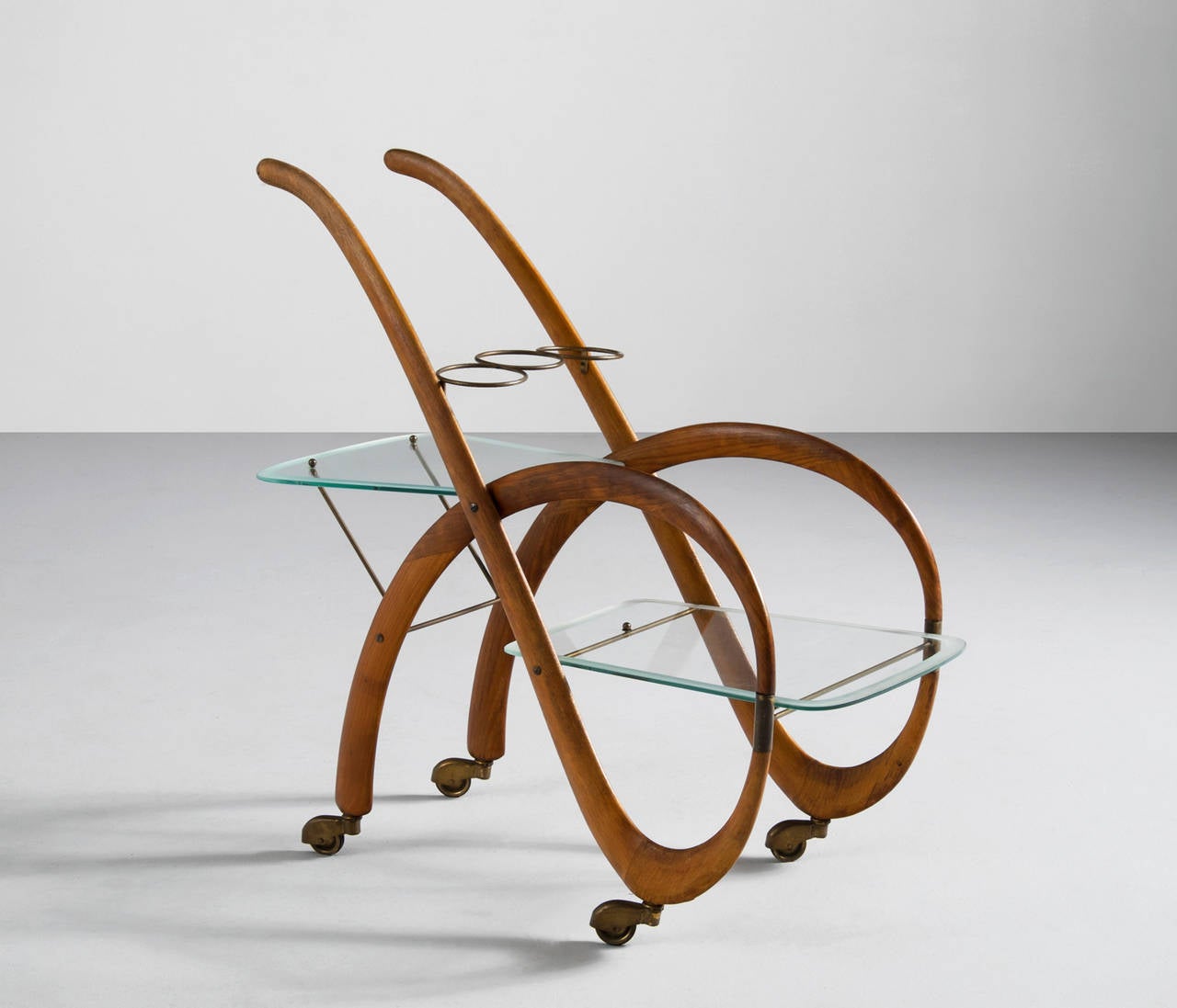 Lovely designed liquor trolley, Italy 1960's. 

Very well executed, in the style of Carlo Mollino.

The main frame is gently shaped in curved beechwood, with two glass tops and a botttle rack in the middle of the serving cart. 
The transparant