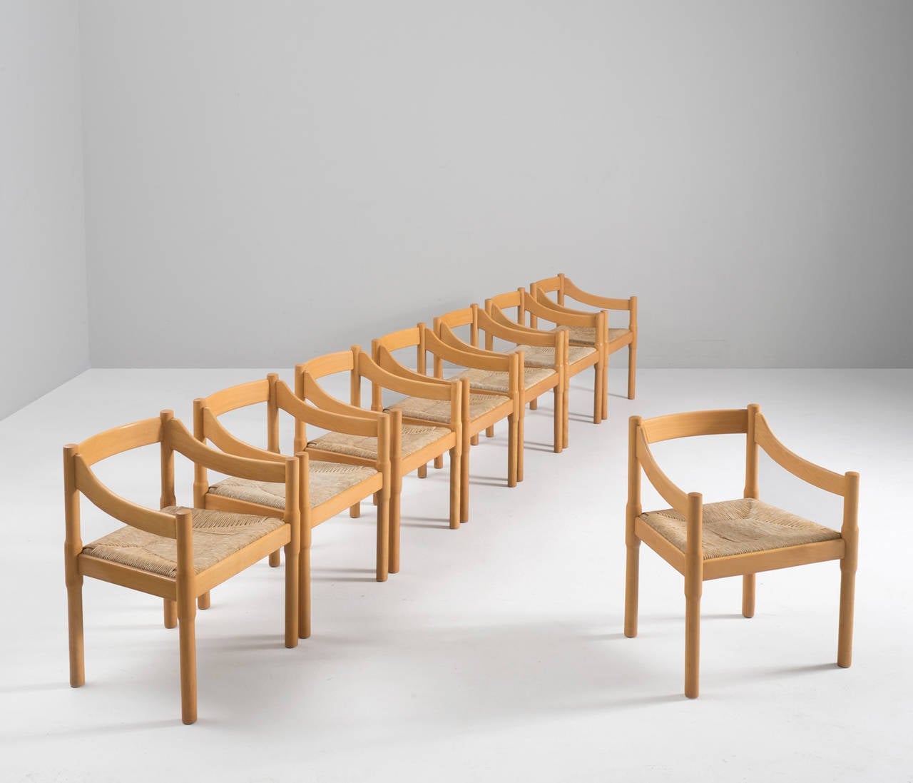 Set of 21 'Carimate' chairs, in beech and rope, by Vico Magistretti for Cassina, Italy 1963. 

This iconic design was considered the symbol of Swinging London during the 1950s. The basic shape of the beech wooden frame is remarkably simple and