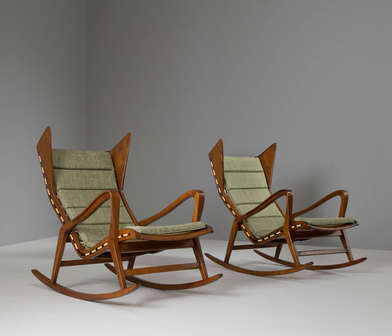 A pair of lounge chairs, in walnut and fabric, for Cassina, Italy, 1950s.

Very rare set of rocking chairs in walnut designed by the Italian company Cassina, in the style of Gio Ponti. Exquisite production techniques used which are shown by the