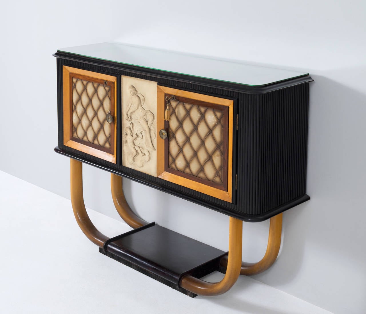 Very decorative and impressive Italian sideboard including dry bar option designed in the manner of Vittorio Dassi, Italy, 1950s.

This cabinet is made of a diversity of materials such as different types of wood, a glass top, brass details and