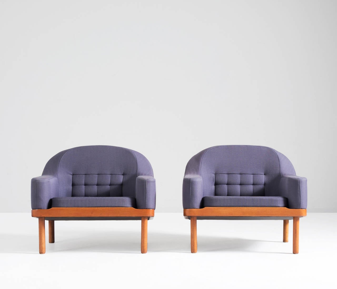 Beautifully designed Scandinavian lounge chairs. The chairs are covered in a very special way with a nice dark purple fabric. This gives a nice contrast with the well-formed, minimalistic teak frame. 

Free shipping for all European destinations