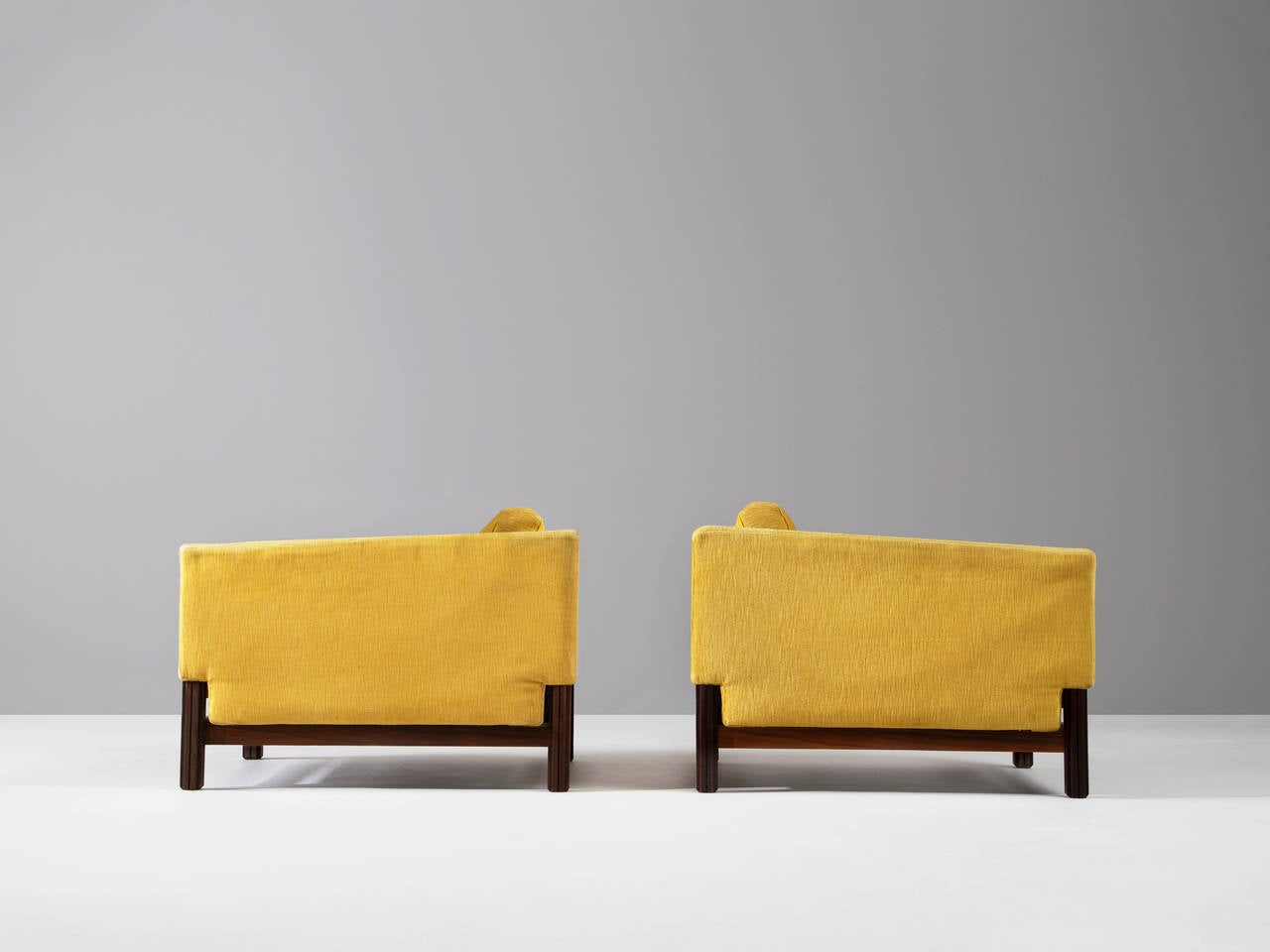 Set of two club chairs in rosewood and fabric for Saporiti, Italy, 1960s.

These chairs, equipped with a solid rosewood frame still holds its original yellow upholstery. This chairs are designed in order to give it that very distinguished low look.