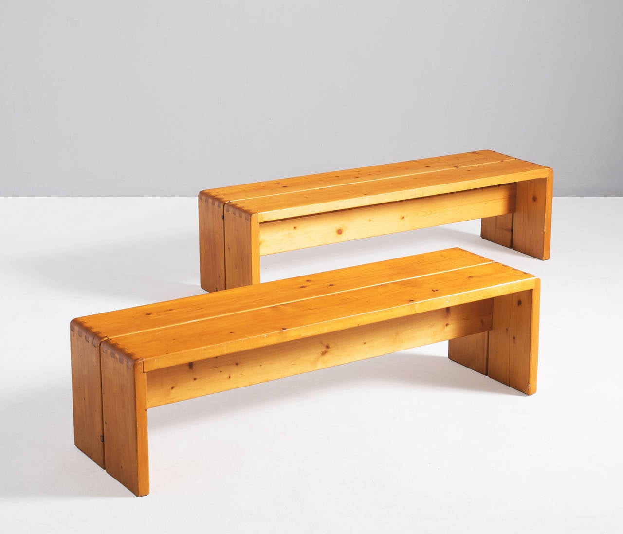 Set of two benches in solid pine by Charlotte Perriand designed for 'Les Arcs', 1960's. Very solid construction, well made designed wood joints.

Les Arcs opened their first (ski)resort in 1968 named 'Arc 1600'. 
Instantly, the modern