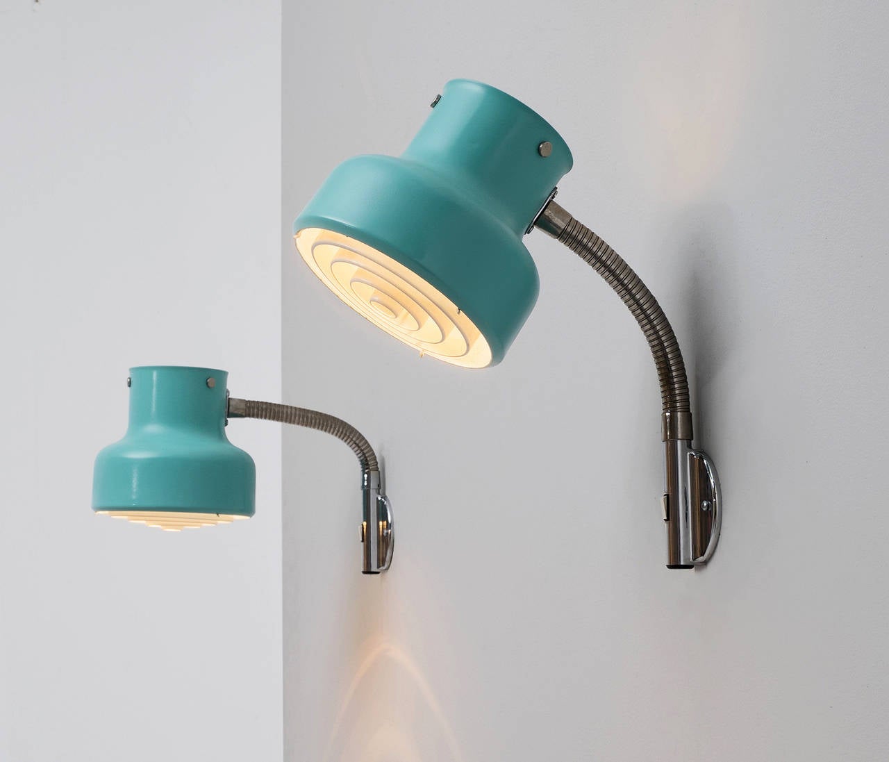 Ateljé Lyktan, Anders Pehrson, wall lights, steel, Sweden, 1970s.

These adjustable wall lights feature a turquoise to green shade with several steel rings in the interior of the shade. These rings result in a mellow light partition. The shade is