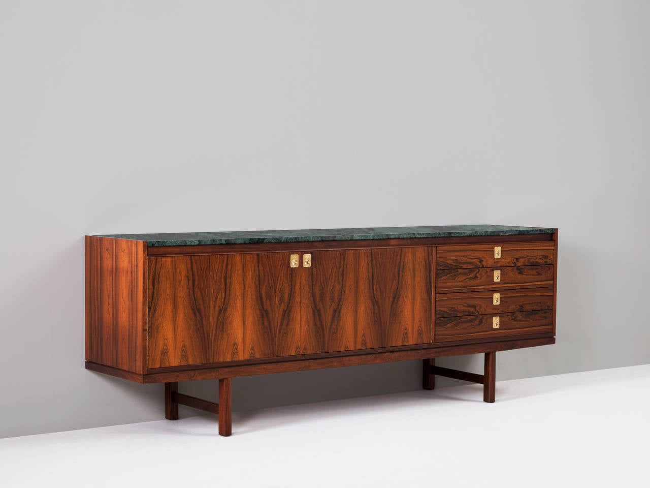 Very special rosewood sideboard designed by Robert Heritage with marble top is to be considered the most unique variant.

Equipped with four drawers accompanied with highly refined inlaid brass handles. This well designed sideboard has been