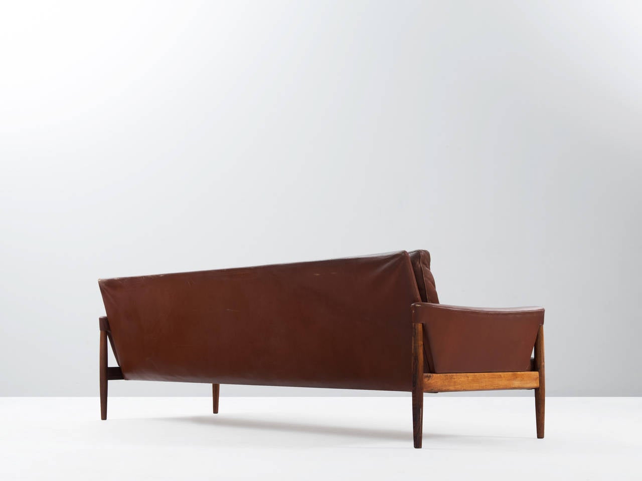 Superb designed four-seat sofa from Danish origin, 1960s.

This sofa, which is still upholstered in it's original leather. Has been designed with some very nice details, which can be seen in the armrest and the shape of the tapered legs, which are