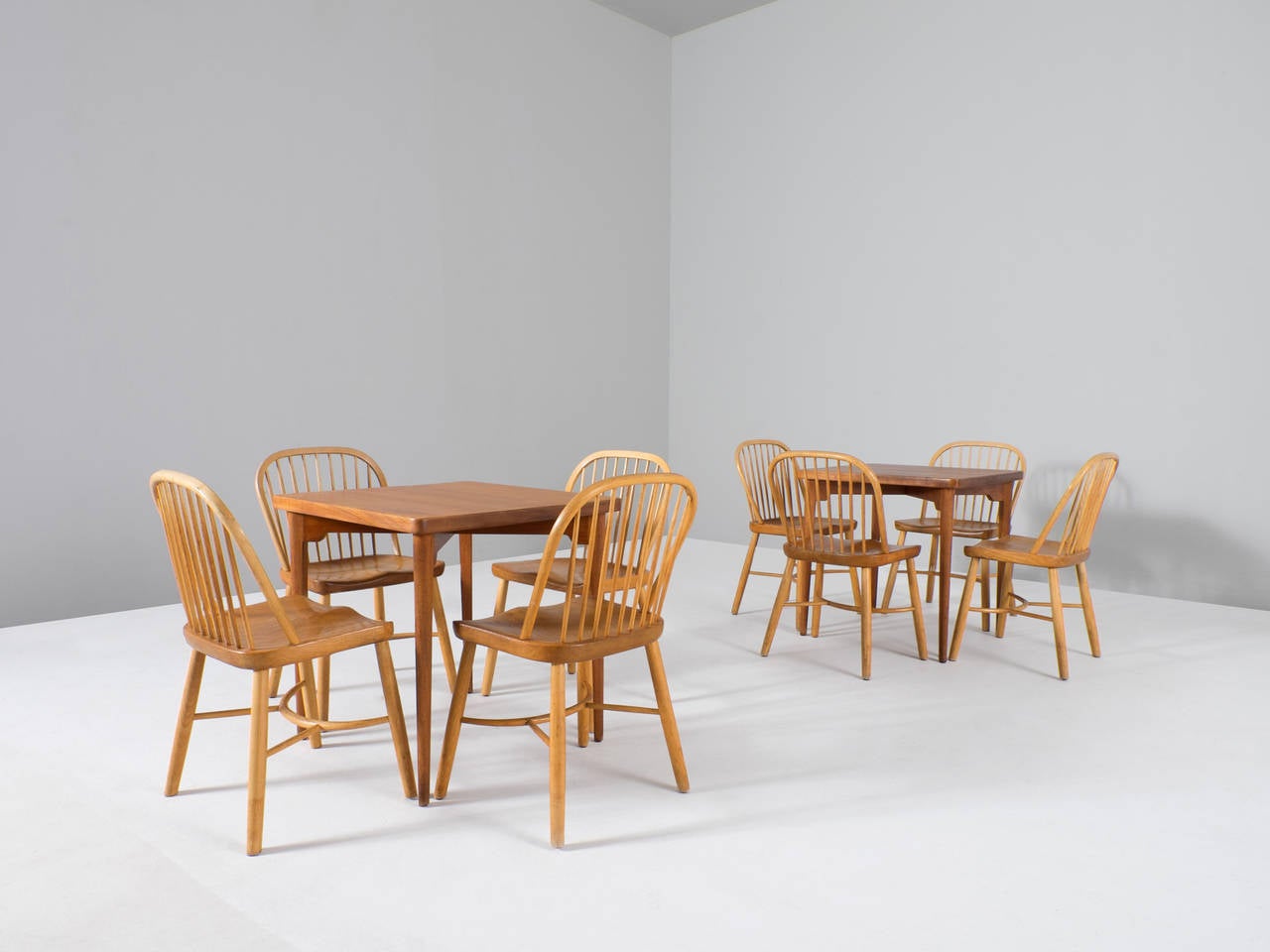 Two Scandinavian dining sets. The chairs are made of beech and the seats of solid teak. The tables are made of teak. Designed by Palle Suenson, originally produced by Fritz Hansen. 

Made in the 1940s under architectural accompaniment for the city