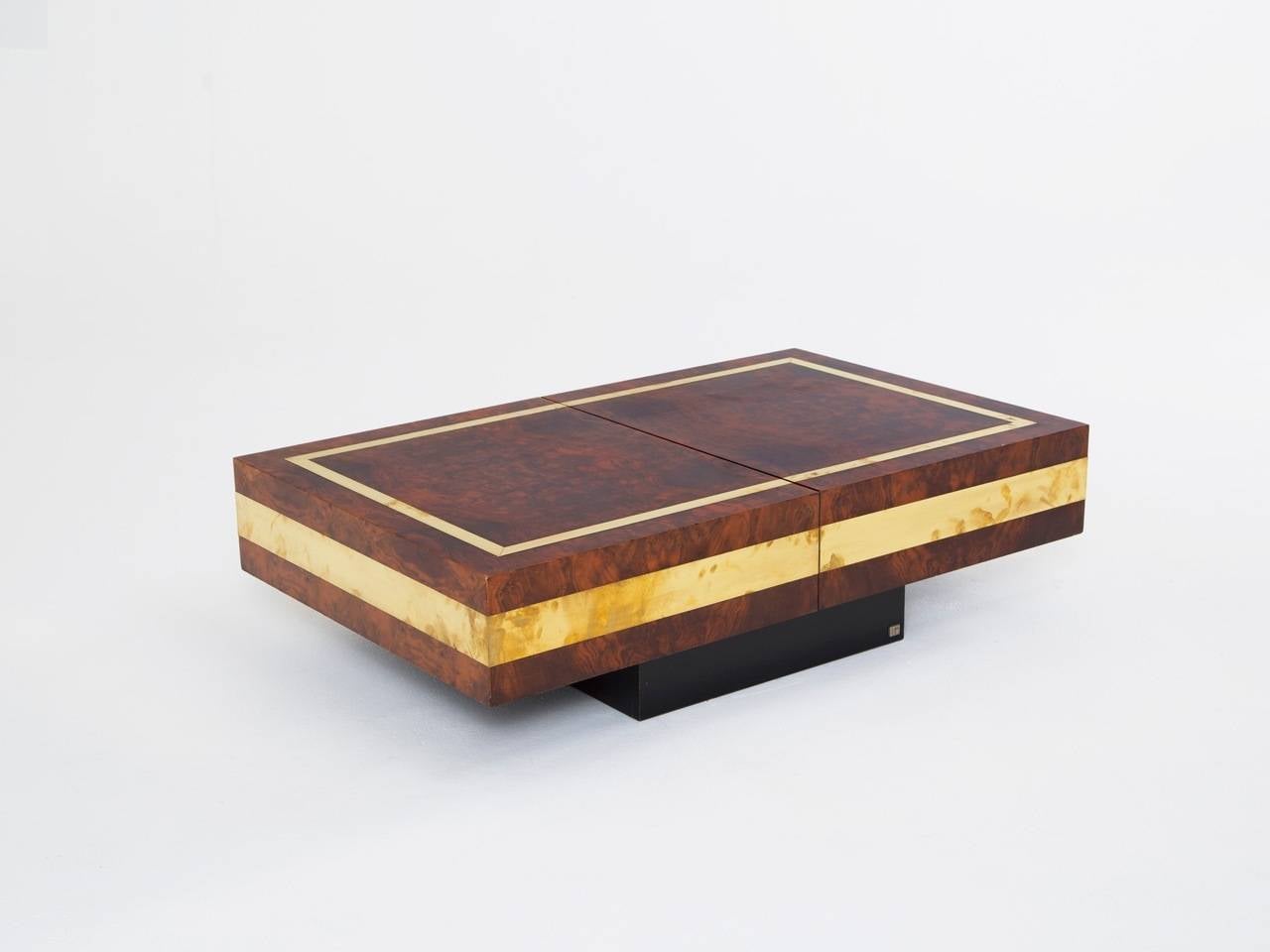 Coffee table designed by Jean Claude Mahey, burl and brass, France, 1970s.

The cherry burl wood has a very warm expression and especially in combination with the solid brass detailing in the top and on the sides of the table, it has a very