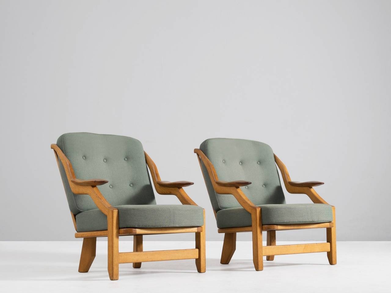 An extraordinary pair of armchairs designed by Guillerme et Chambron, France, 1950's.

Guillerme and Chambron is known for their extreme high quality solid oak furniture, from which this is another example. This pair has a very interesting shape