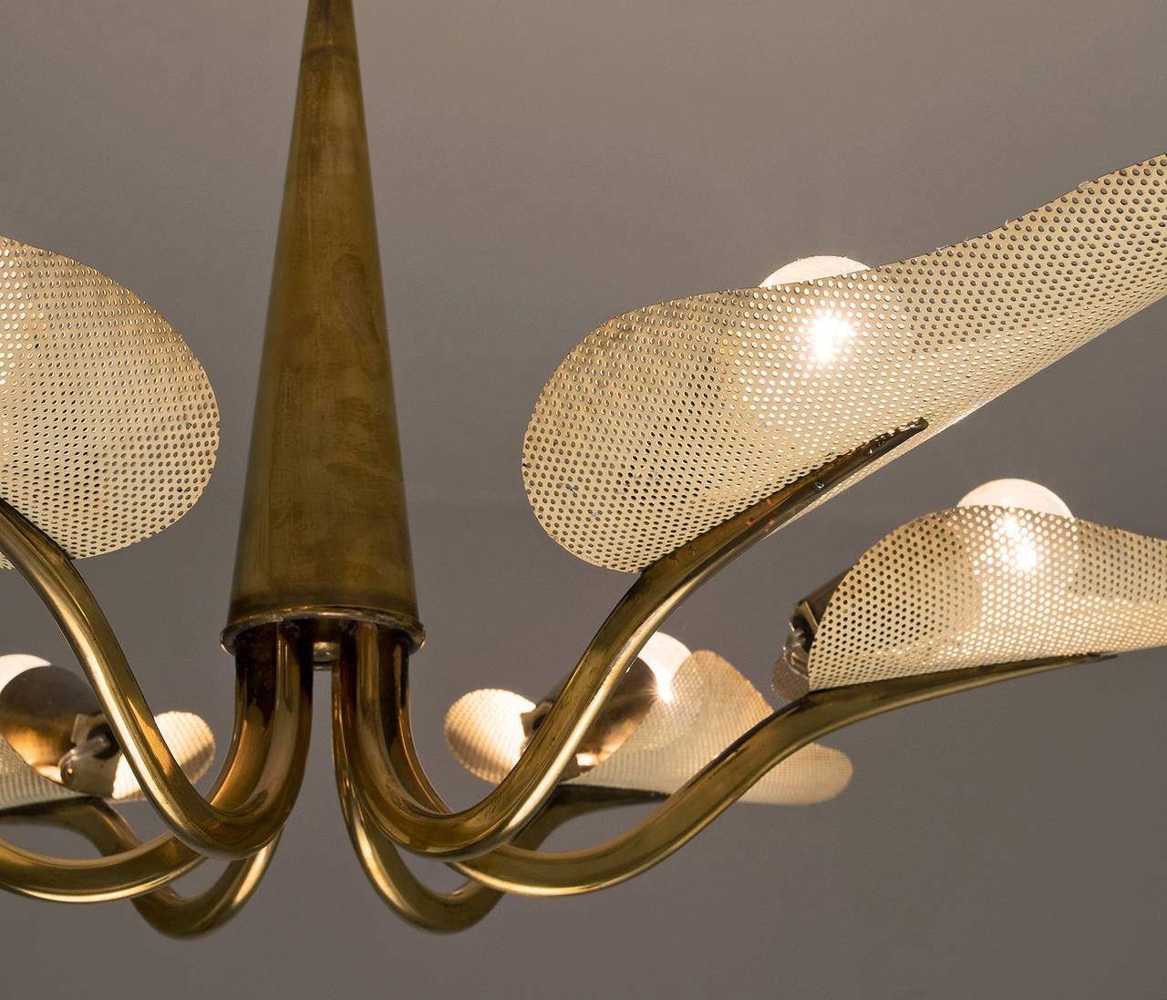 Very elegant chandelier, made in France, late 1950s. 

This wonderful fixture has six elegantly curved arms, with leaf shaped shades in perforated sheet metal. The shades spread a nice diffuse light downwards, and provide clear lighting up as