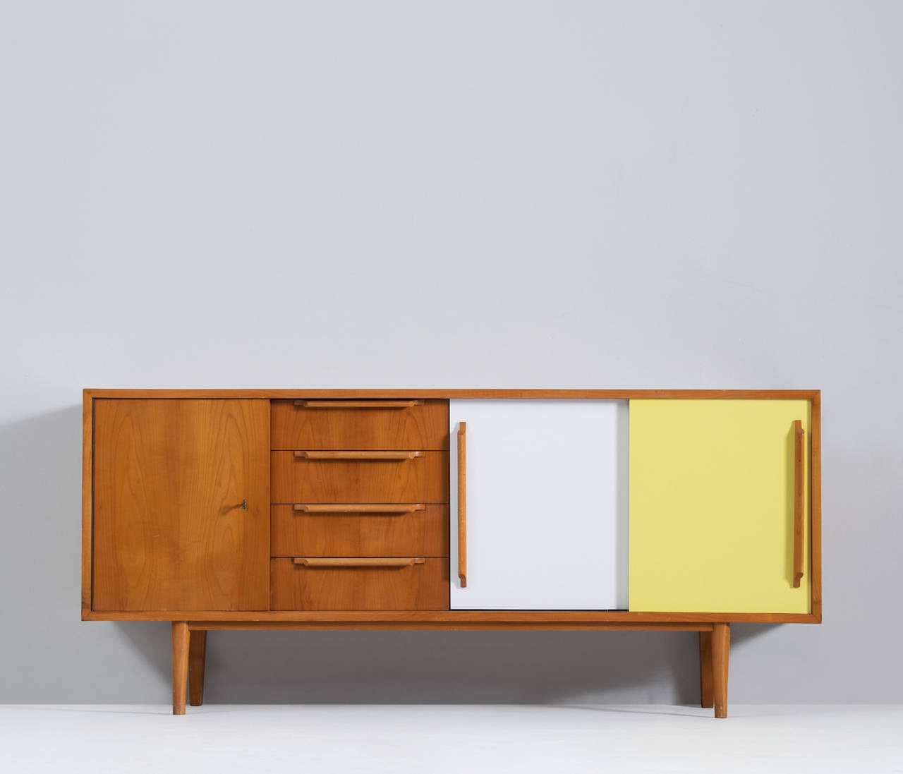 Sideboard designed for Belgium manufacture Van den Berghe-Pouvers, 1950s.

High quality piece, with elegant details. For instance, the warm look and grain of the cherrywood is in nice contrast reflected by the colored sliding doors.

The