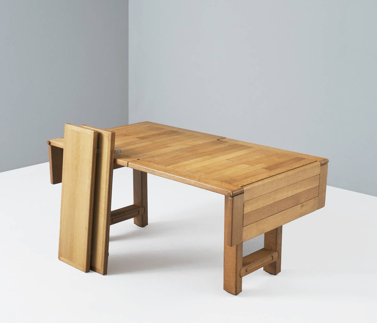 Dining table model 'Bourbonnais', in oak, by Guillerme & Chambron, France 1970s.

The solid frame together with the extendible leaves are in a very good working condition. The leaves are 'hidden' under the top and this table could easily be