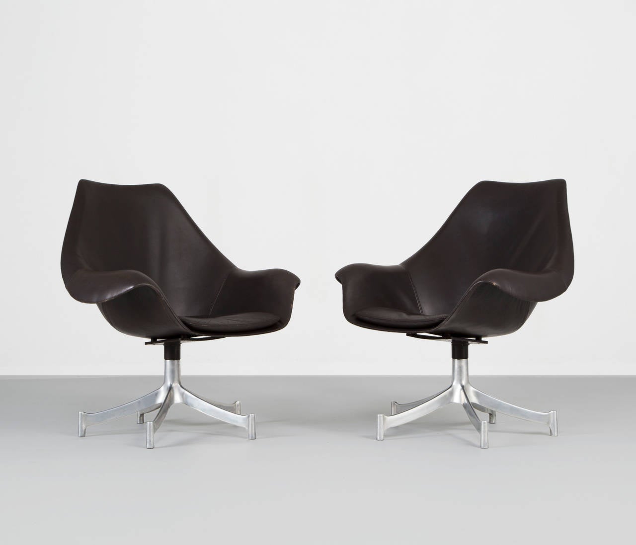 Set of Two Office Chairs designed by Jørgen Lund & Ole Larsen.

The chairs are upholstered in original thick patinated very dark-brown leather. Loose seat cushion. Five-star aluminum foot on casters. Produced by Bo-Ex.
In great vintage