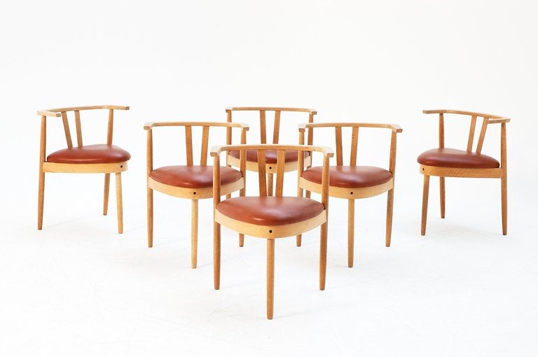 Hans Olsen, dining chairs, oak, cognac faux leather, Denmark, ca. 1960

The chairs have been produced from solid oak which gives a very rich and elegant look. The wood is in very nice contrast with the leather upholstery. All the chairs have been