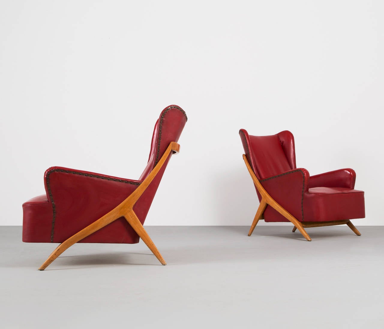 Set of two lounge chairs by Mario Gottardi, Italy.

A very elegant set of chairs of excellent quality and very well constructed manufacture. Wonderful organic details in the legs.

The seats are covered in their original red skai leather which
