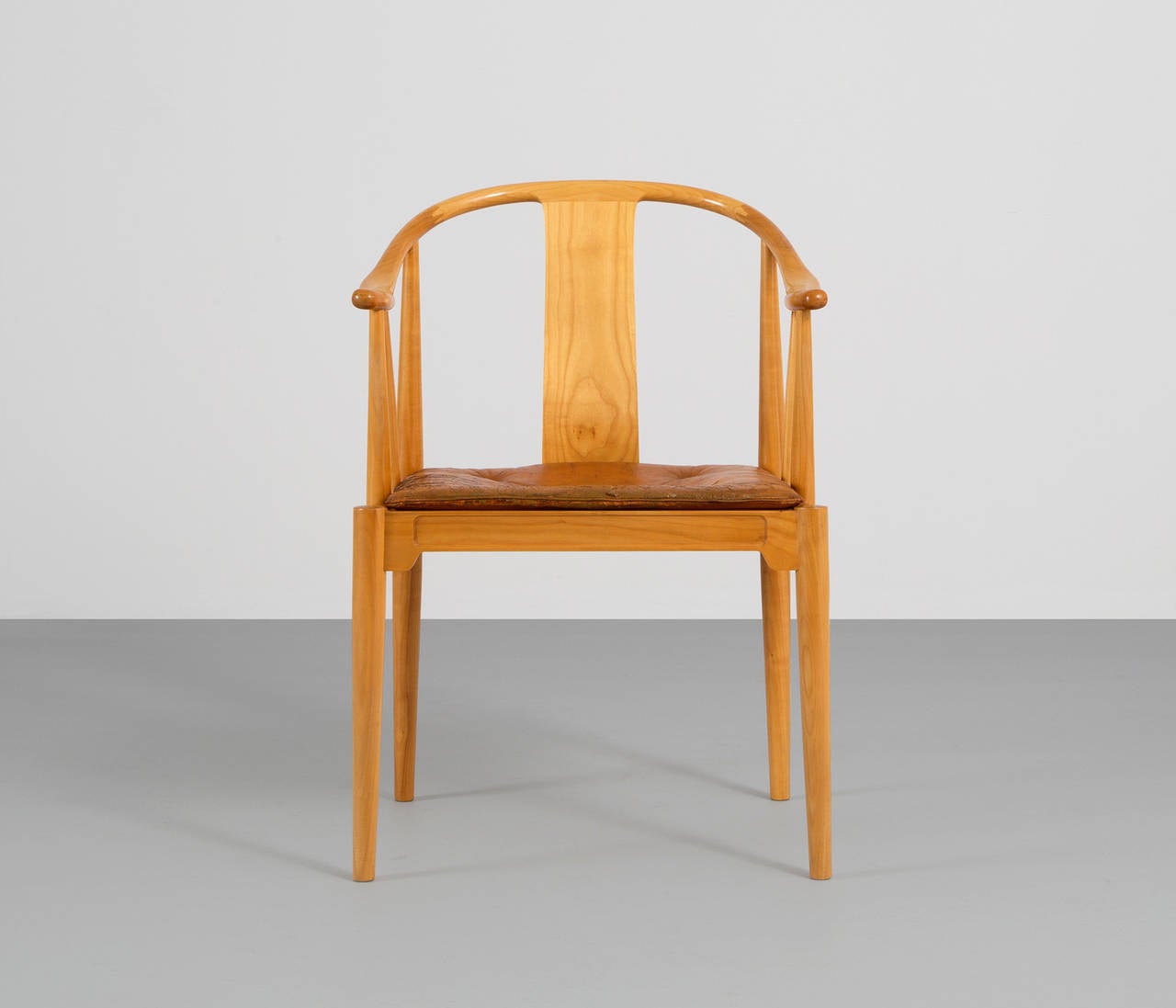Early China chair by Hans Wegner for Fritz Hansen.

This version is made from solid ash wood and is accompanied with the original cognac colored seat-cushion.

Hans Wegner was cabinet-maker and furniture designer and one of the principals of