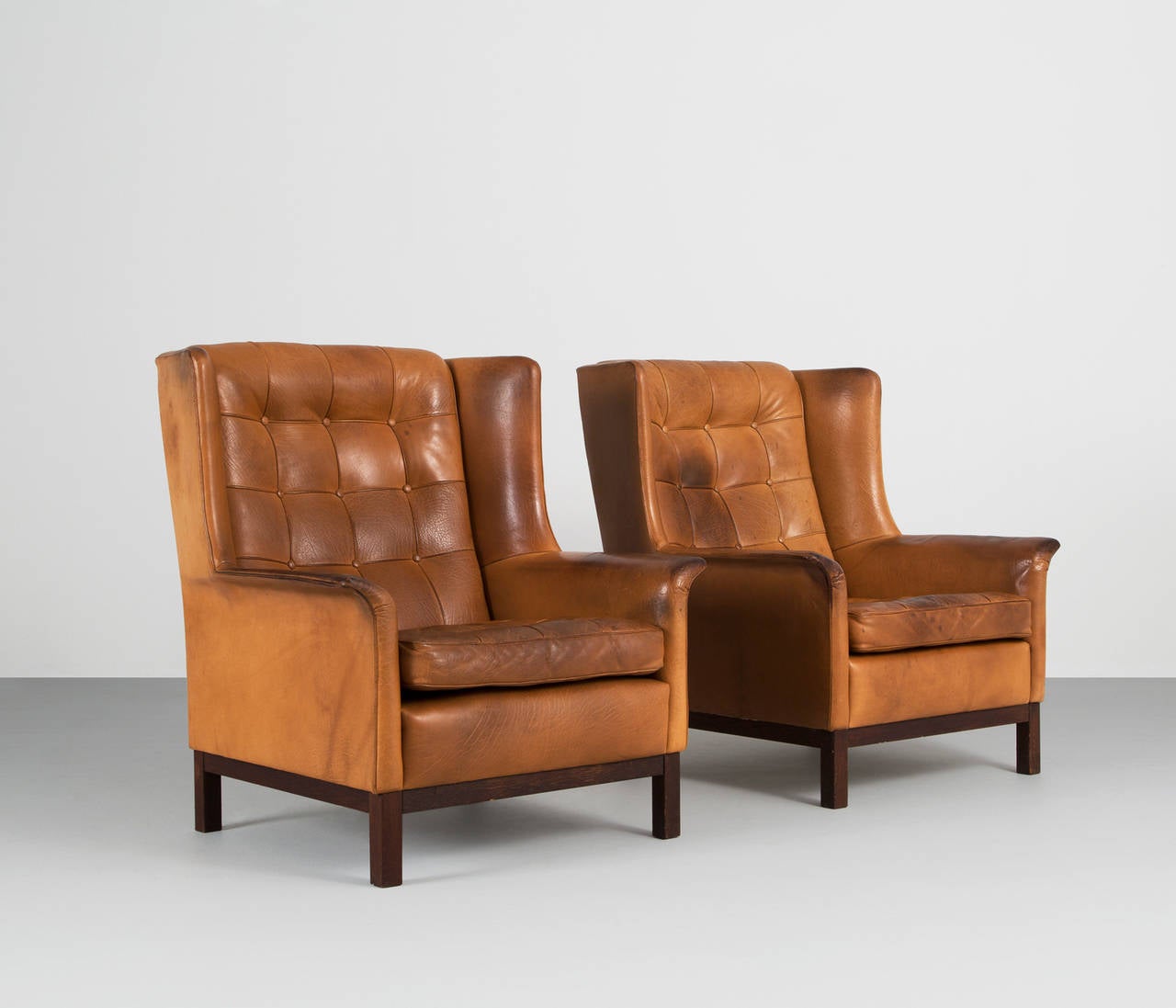 Pair of highback chairs, in leather and rosewood, by Arne Norell, Sweden, 1960s. 

Wonderful pair of comfortable cognac buffalo leather easy chairs by Arne Norell. These chairs come with a very high standard of comfort, as where Norell is known