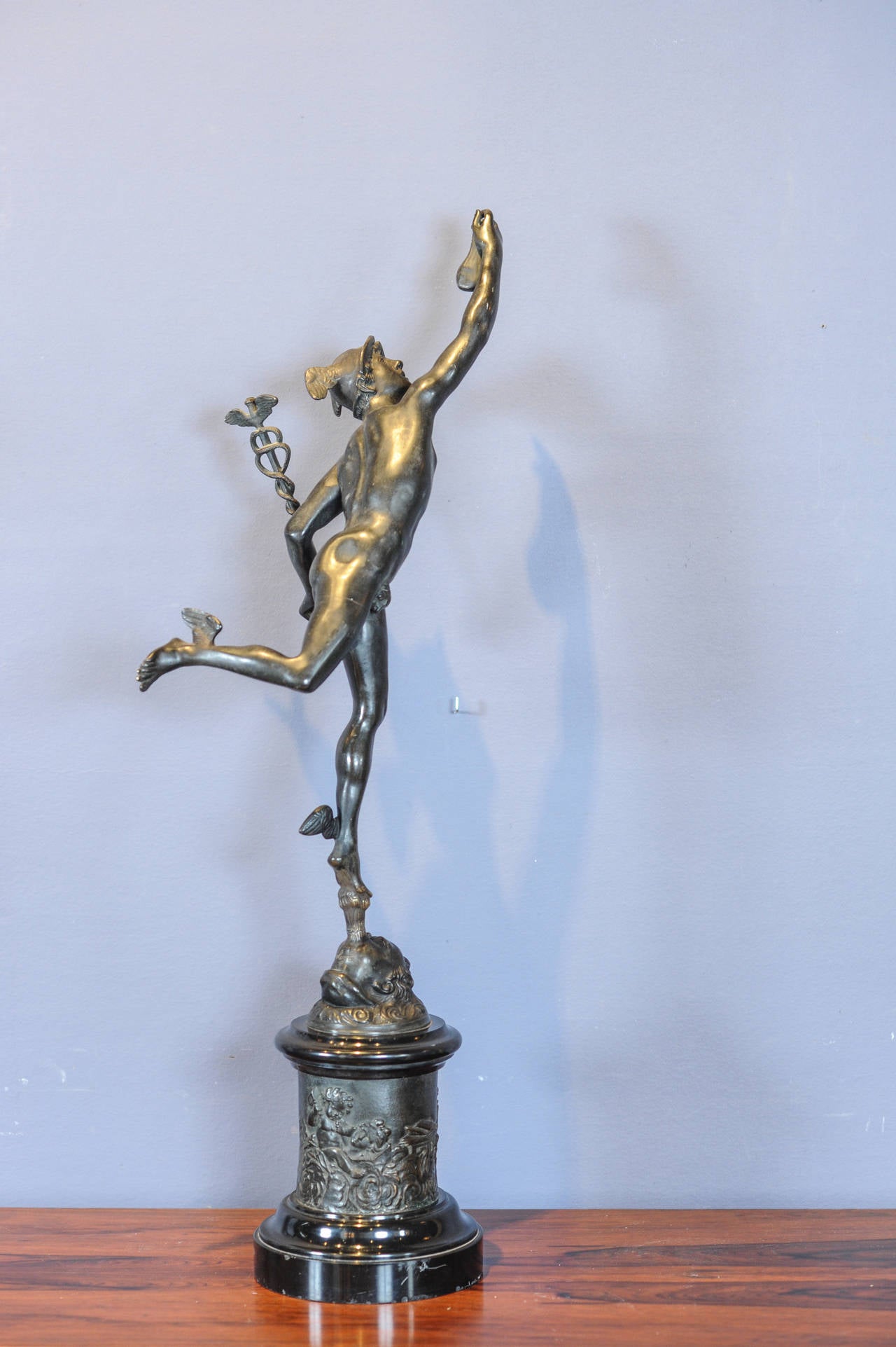 A large late 19th Century patinated bronze sculpture of Hermes / Mercury after the famous design by Giambologna (Jean (de) Boulogne) from ca. 1580, signed 'J Bologne' on the cherub (personification of the wind).