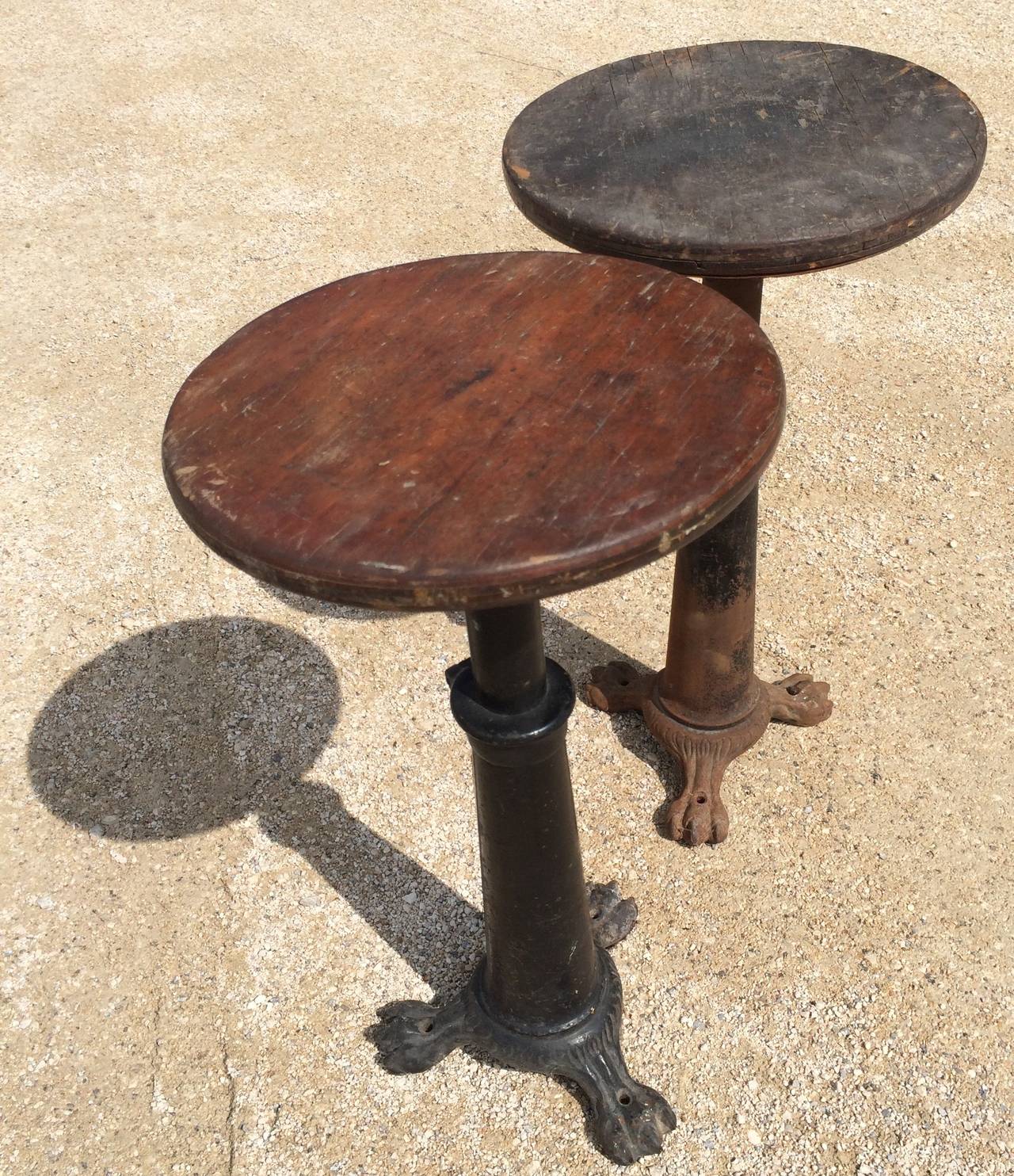 Three in total, all with the original round wooden seat and spiral adjust system, two unmarked, the one photographed singly with remnants of red paint and marked 