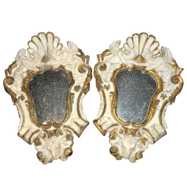 A pair of antique Italian wooden plaster mirrors