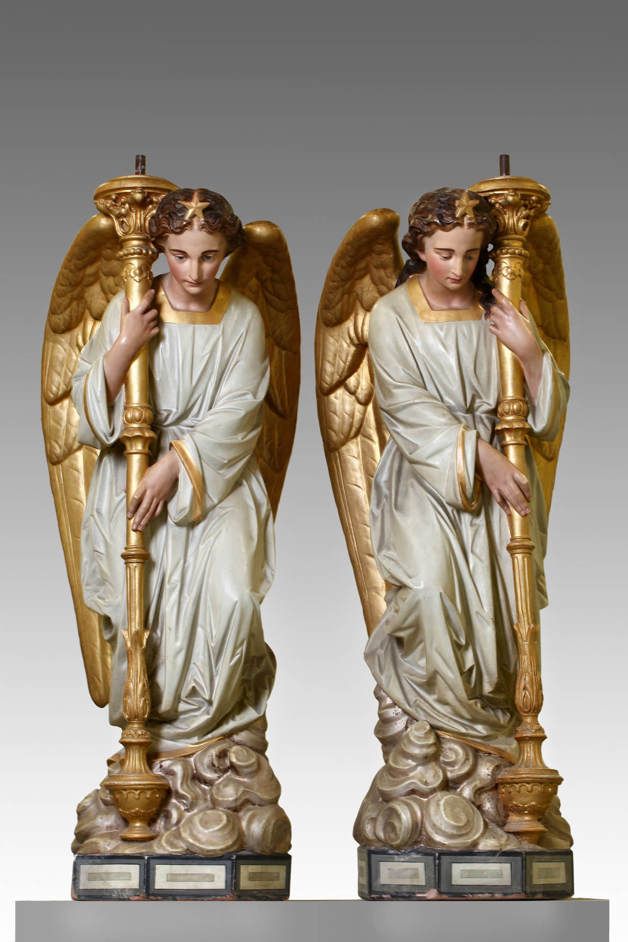 Third quarter 19th century, portrayed as standing and opposing, clasping a standard torchere in both hands to the left shoulder and right shoulder respectively. Measures: 145 cm, high.