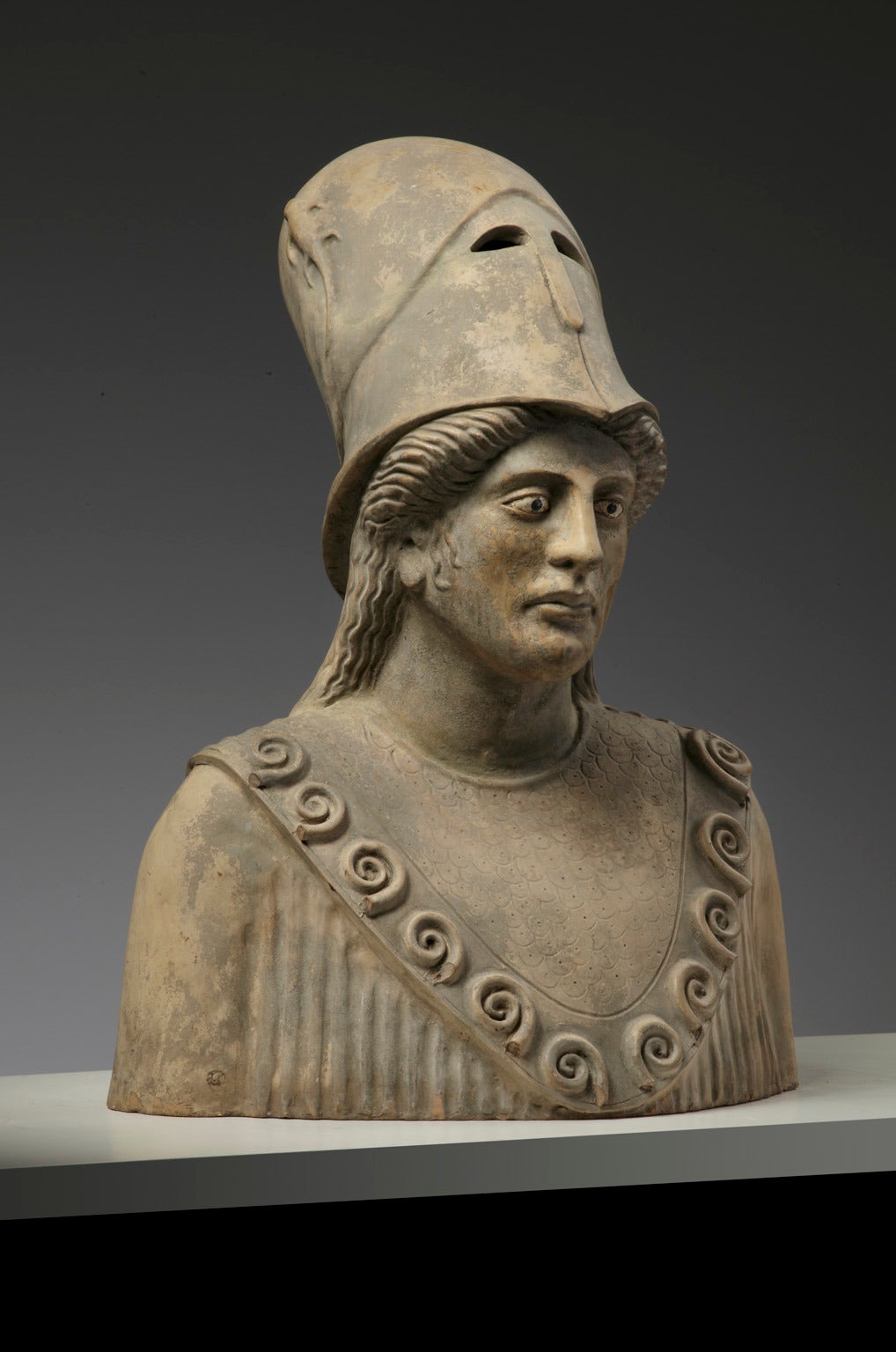 in the manner of antique examples, the helmet modelled with a lizard in relief pushed back, the 'chiton' with scrollwork to the 'decolletage'.

This bust bears similarities to the 'Athena Giustiniani', a Roman marble of the late 5th - early 4th