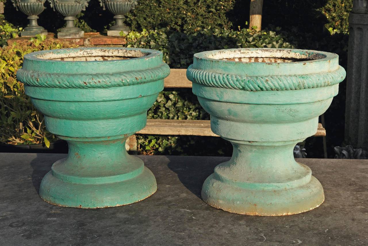 Pair of 18th century cast iron garden urns. Each of circular section with knopped and waisted bodies.