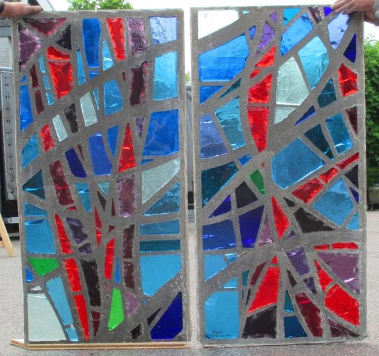 A pair of coloured glass-in-cement monastery windows executed in 1962 for a Dyon monastery. Cast coloured glass, handcut into forms and shapes. Signed and dated.
Marcel Parot, master glass maker, was a pupil of Felix and Pierre Gaudin. He founded