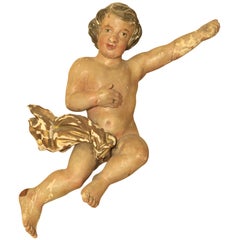 An early 18th century Dutch Baroque polychrome painted carved wooden putto